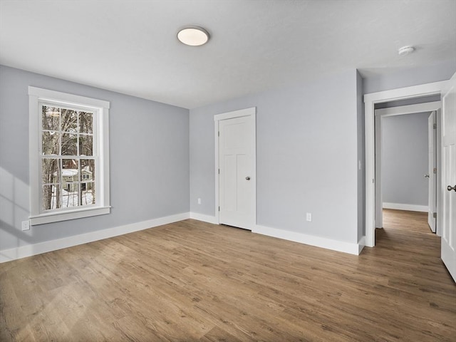 empty room with hardwood / wood-style floors