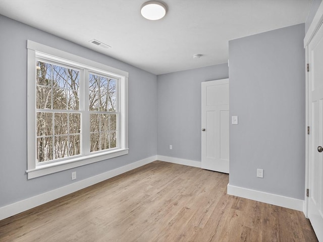 spare room featuring light hardwood / wood-style floors