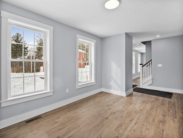 unfurnished room with light wood-type flooring