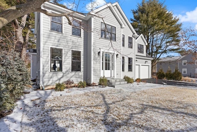 view of front of home featuring aphalt driveway and an attached garage