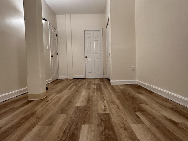 interior space featuring baseboards and wood finished floors