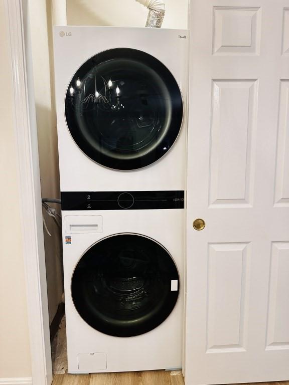 clothes washing area with stacked washer / drying machine and laundry area