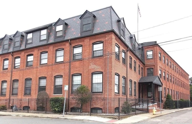 view of building exterior with fence