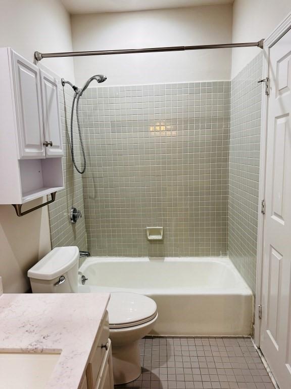 bathroom with toilet, tile patterned flooring, vanity, and bathing tub / shower combination