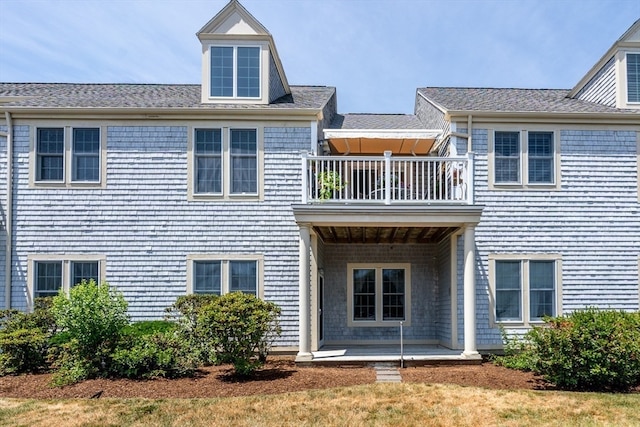 rear view of house featuring a balcony