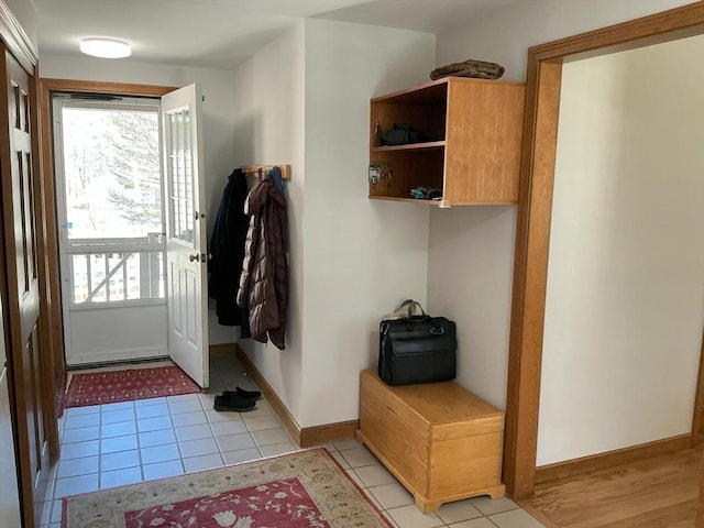 mudroom featuring baseboards and light tile patterned floors