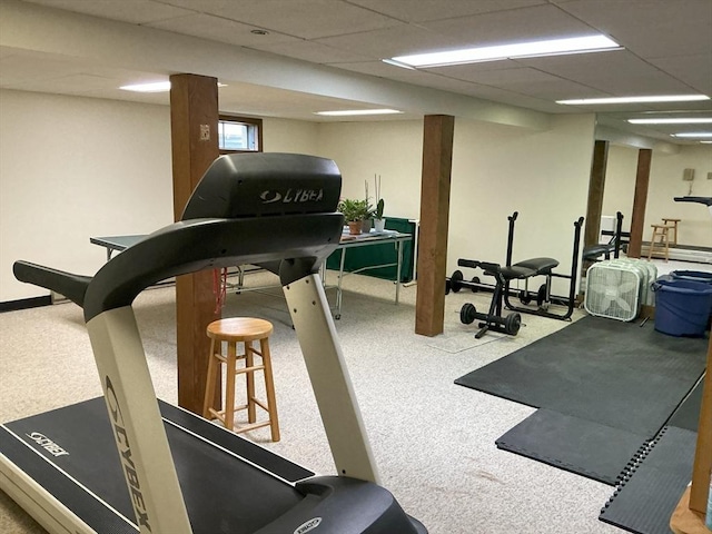 workout area featuring carpet flooring and a drop ceiling