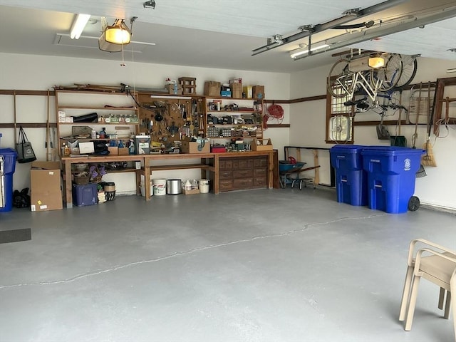 garage featuring a garage door opener and a workshop area