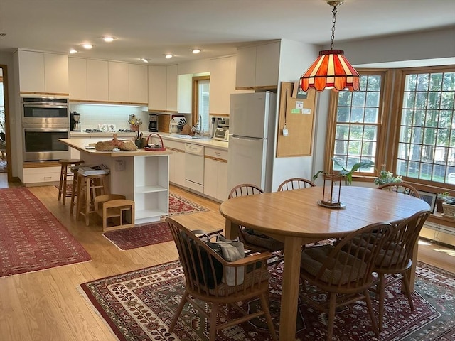 dining area with recessed lighting and light wood-type flooring