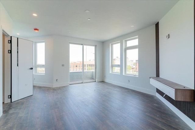 29 Woodford St Unit 2, Boston, MA 02125 - unfurnished living room with wood finished floors, baseboards, and recessed lighting