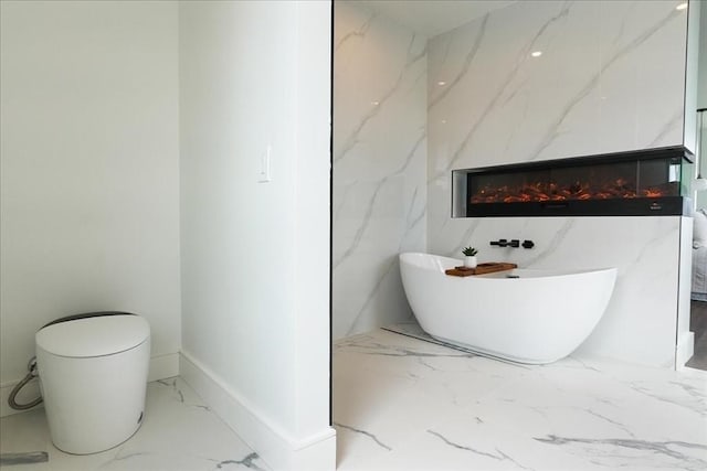29 Woodford St Unit 2, Boston, MA 02125 - bathroom featuring marble tiled flooring, a soaking tub, toilet, and a fireplace