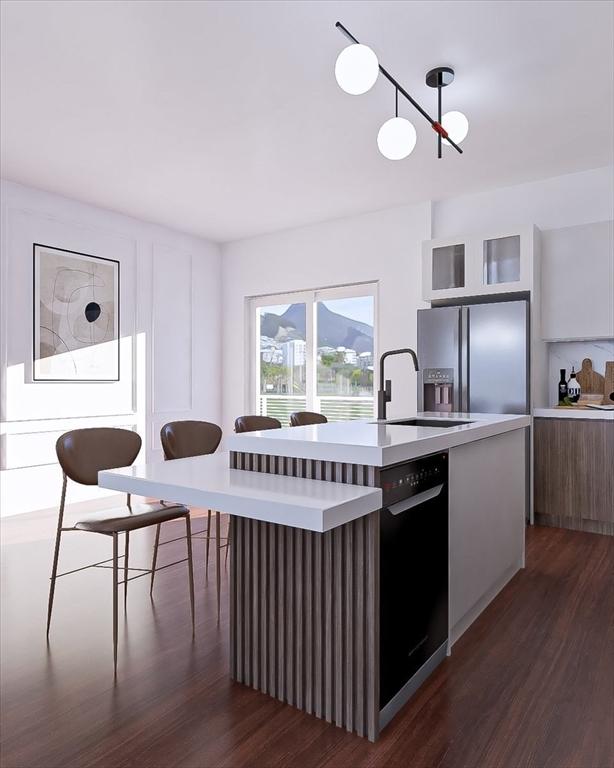 29 Woodford St Unit 2, Boston, MA 02125 - kitchen with stainless steel refrigerator with ice dispenser, modern cabinets, dark wood-style flooring, light countertops, and a kitchen island with sink