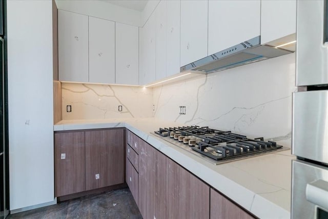 29 Woodford St Unit 2, Boston, MA 02125 - kitchen with stainless steel appliances, under cabinet range hood, decorative backsplash, and white cabinetry
