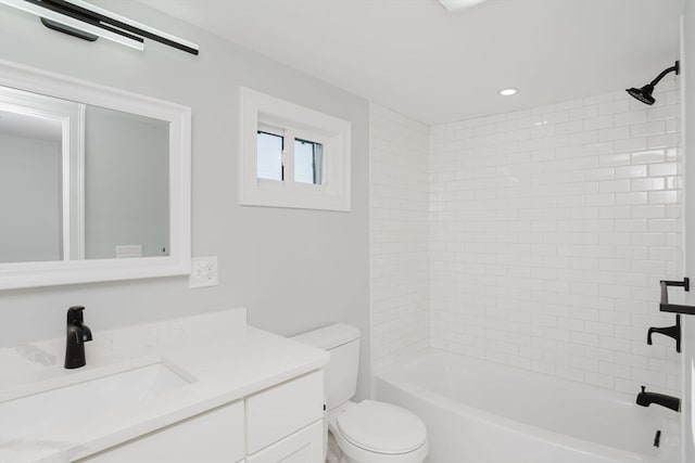 full bathroom featuring vanity, toilet, and tiled shower / bath