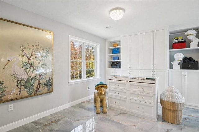 spacious closet with marble finish floor