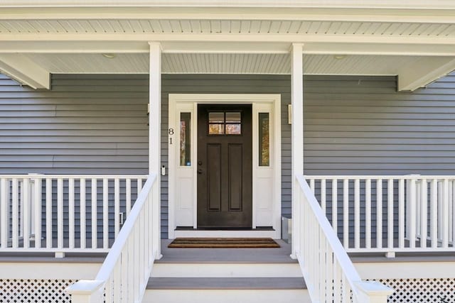 doorway to property featuring covered porch