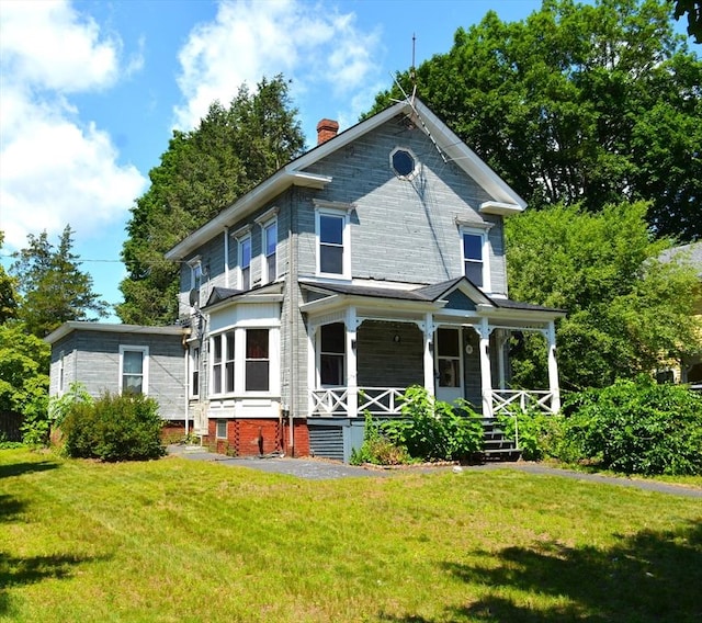 19 Noble Ave, Westfield, MA 01085 - victorian house with covered porch, a front yard, and a chimney