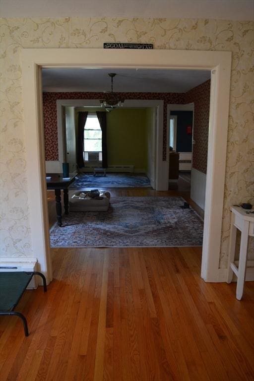 19 Noble Ave, Westfield, MA 01085 - corridor featuring wallpapered walls, wood finished floors, a chandelier, and radiator heating unit