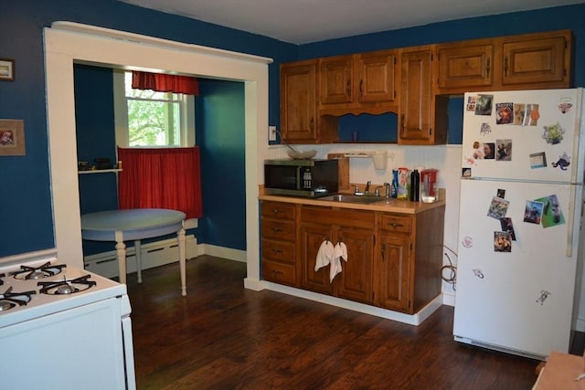 19 Noble Ave, Westfield, MA 01085 - kitchen featuring white appliances, a baseboard heating unit, dark wood-style flooring, brown cabinetry, and light countertops