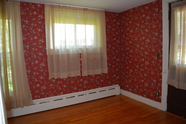 19 Noble Ave, Westfield, MA 01085 - unfurnished room with a baseboard heating unit, healthy amount of natural light, and wood finished floors