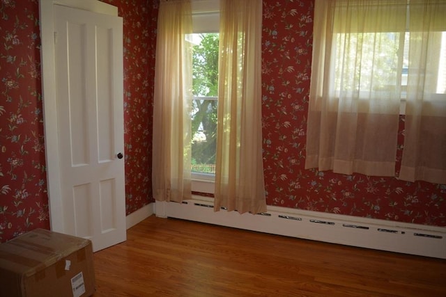 19 Noble Ave, Westfield, MA 01085 - spare room with baseboard heating, wood finished floors, and wallpapered walls