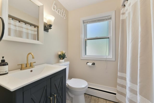 1026 Chandler St, Tewksbury, MA 01876 - bathroom featuring a baseboard radiator, vanity, and wood finished floors