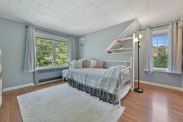 1026 Chandler St, Tewksbury, MA 01876 - bedroom featuring radiator heating unit and wood finished floors
