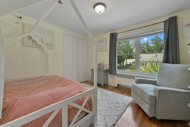 1026 Chandler St, Tewksbury, MA 01876 - bedroom with radiator, wood finished floors, and a closet