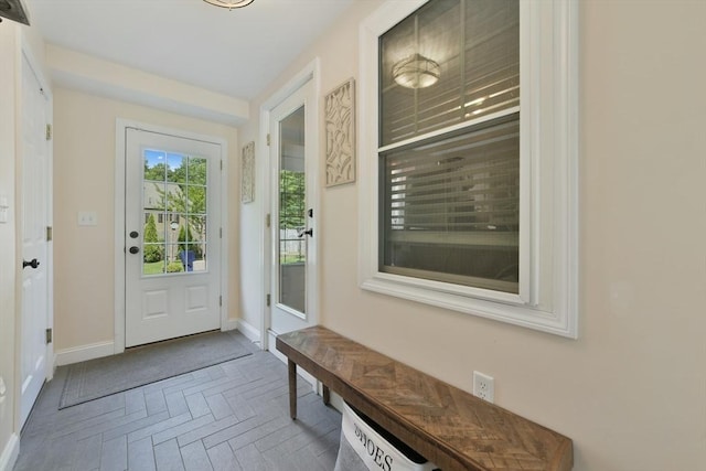 1026 Chandler St, Tewksbury, MA 01876 - doorway to outside featuring baseboards and brick patterned flooring