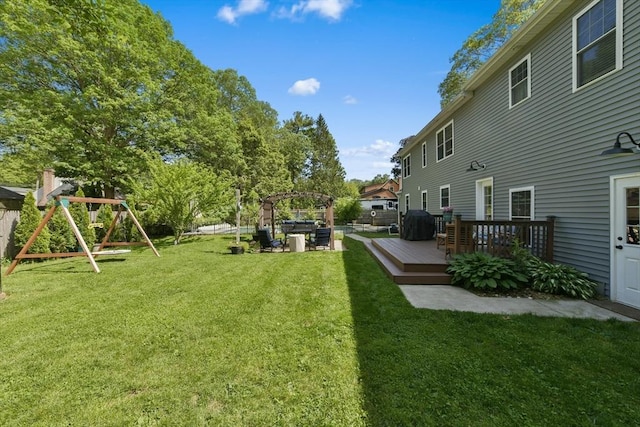 1026 Chandler St, Tewksbury, MA 01876 - view of yard featuring a wooden deck, a pergola, and a playground