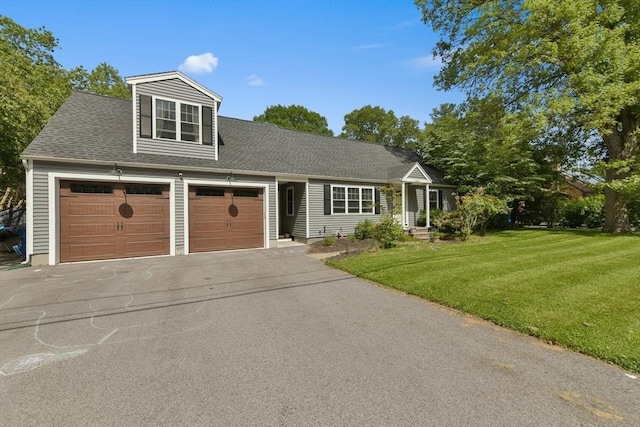 1026 Chandler St, Tewksbury, MA 01876 - view of front facade featuring a front lawn, driveway, roof with shingles, and a garage