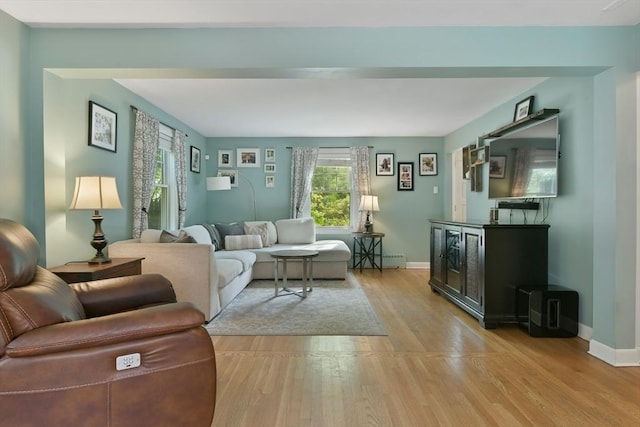 1026 Chandler St, Tewksbury, MA 01876 - living room with baseboard heating and light wood-type flooring