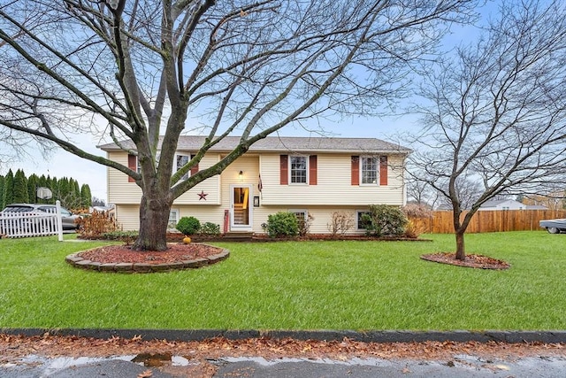 raised ranch featuring a front lawn