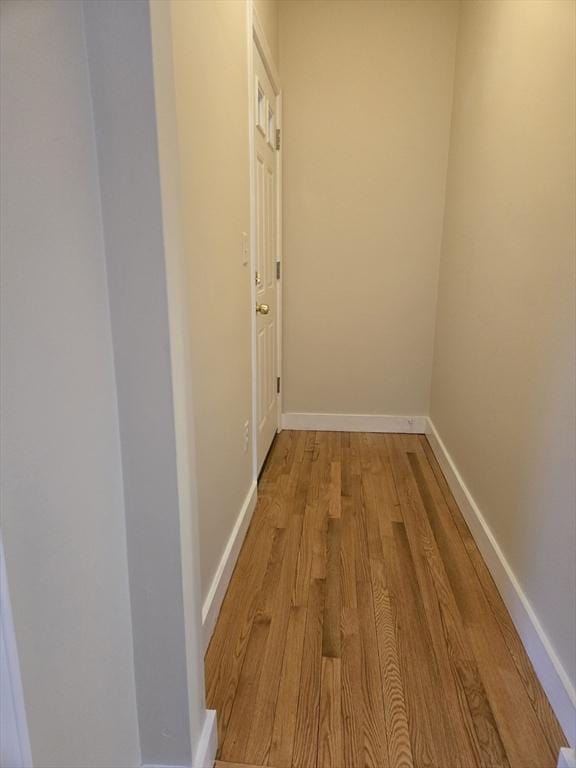 corridor with light wood-type flooring