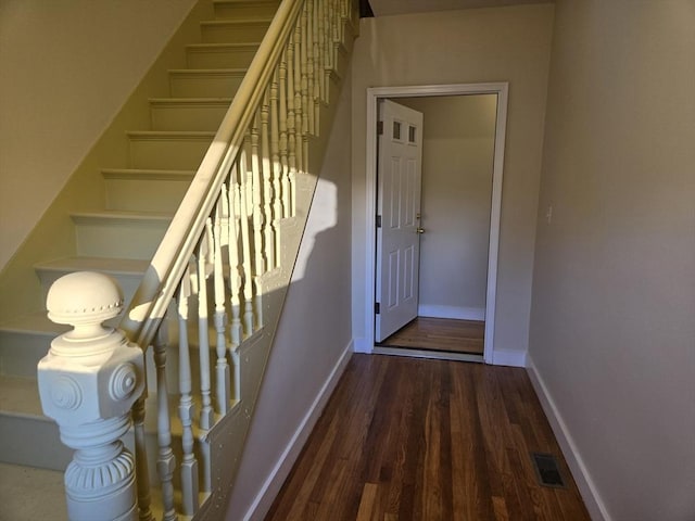 staircase with hardwood / wood-style flooring