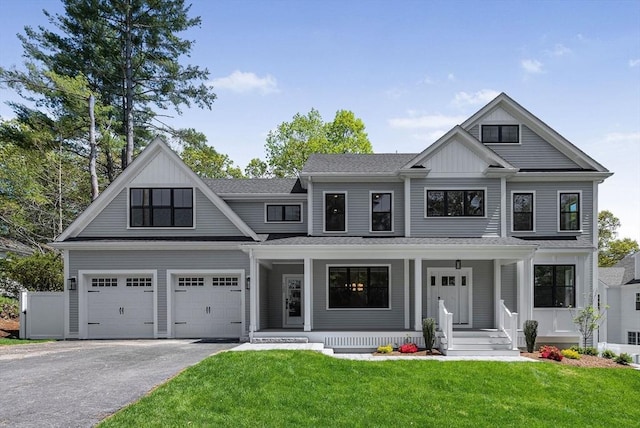 120 Lawton Rd, Needham, MA 02492 - view of front of house featuring a porch, asphalt driveway, a front yard, and board and batten siding