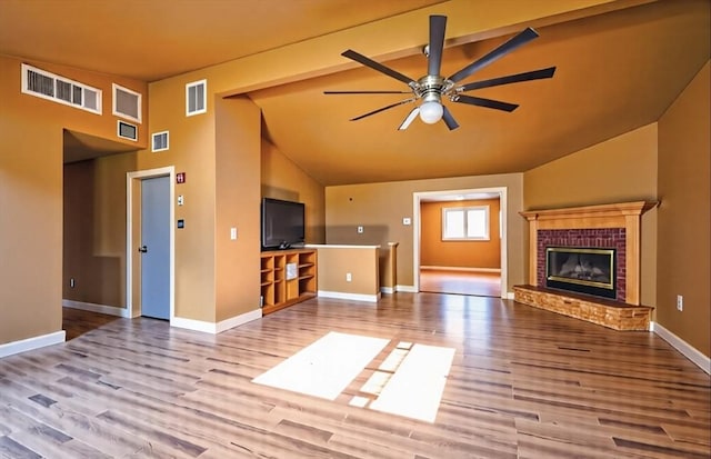 8 High St, Granby, MA 01033 - unfurnished living room with a ceiling fan, wood finished floors, baseboards, a fireplace, and high vaulted ceiling