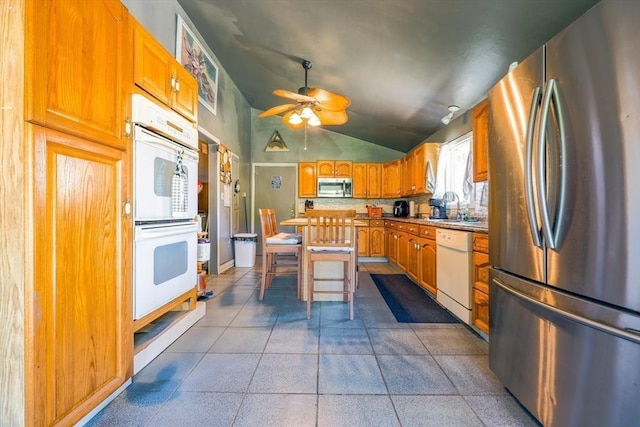 8 High St, Granby, MA 01033 - kitchen featuring appliances with stainless steel finishes, lofted ceiling, a ceiling fan, brown cabinetry, and a sink