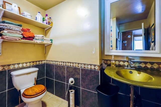8 High St, Granby, MA 01033 - bathroom featuring tile walls, a sink, toilet, tile patterned flooring, and a wainscoted wall