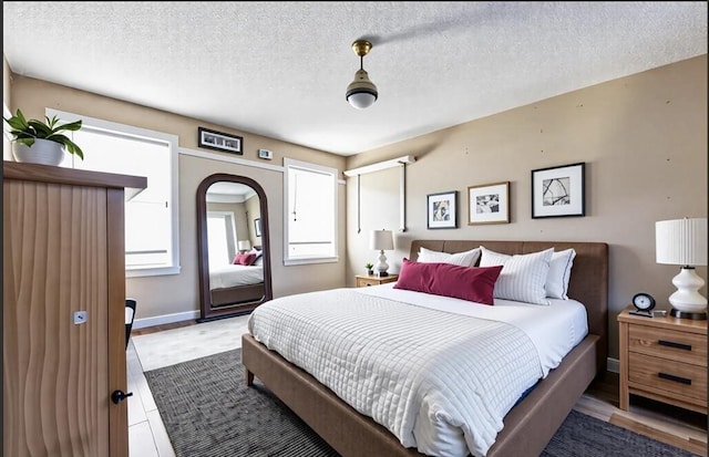 8 High St, Granby, MA 01033 - bedroom with a textured ceiling, baseboards, and arched walkways