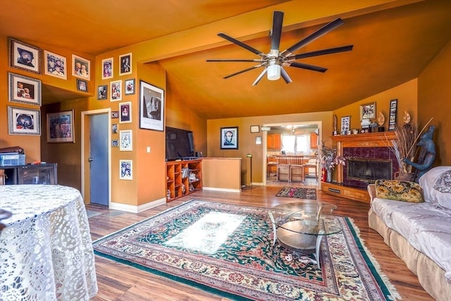 8 High St, Granby, MA 01033 - living area featuring vaulted ceiling, ceiling fan, wood finished floors, a fireplace, and baseboards