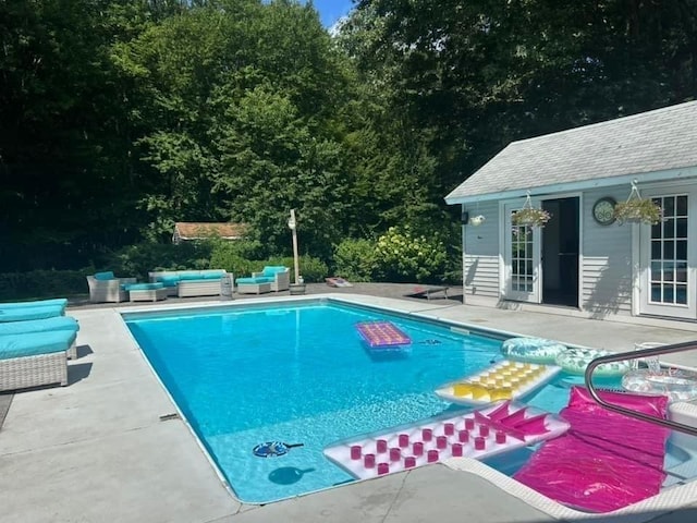 view of pool featuring an outdoor hangout area, a patio, and an outdoor structure