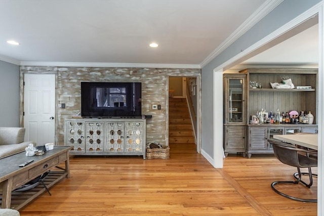 living room featuring light hardwood / wood-style floors and ornamental molding