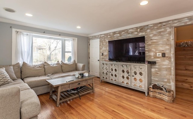 living room featuring ornamental molding and light hardwood / wood-style floors