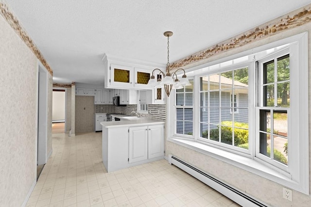 91 Observatory Waye, Marshfield, MA 02050 - kitchen featuring a baseboard radiator, healthy amount of natural light, a peninsula, glass insert cabinets, and a textured ceiling