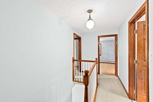91 Observatory Waye, Marshfield, MA 02050 - hall featuring an upstairs landing, light carpet, baseboards, a baseboard heating unit, and a textured ceiling