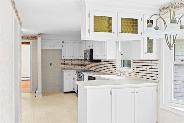 91 Observatory Waye, Marshfield, MA 02050 - kitchen featuring appliances with stainless steel finishes, a sink, light countertops, a baseboard heating unit, and a peninsula