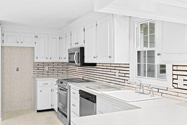 91 Observatory Waye, Marshfield, MA 02050 - kitchen featuring stainless steel appliances, a sink, white cabinets, light countertops, and tasteful backsplash