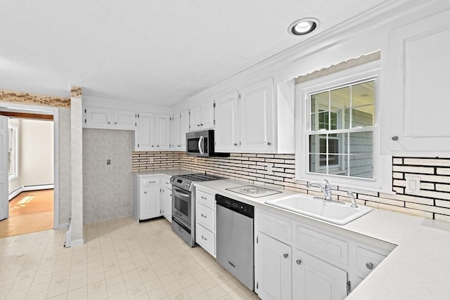 91 Observatory Waye, Marshfield, MA 02050 - kitchen featuring appliances with stainless steel finishes, a sink, light countertops, and white cabinets
