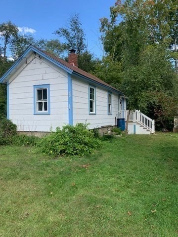 back of house with a yard